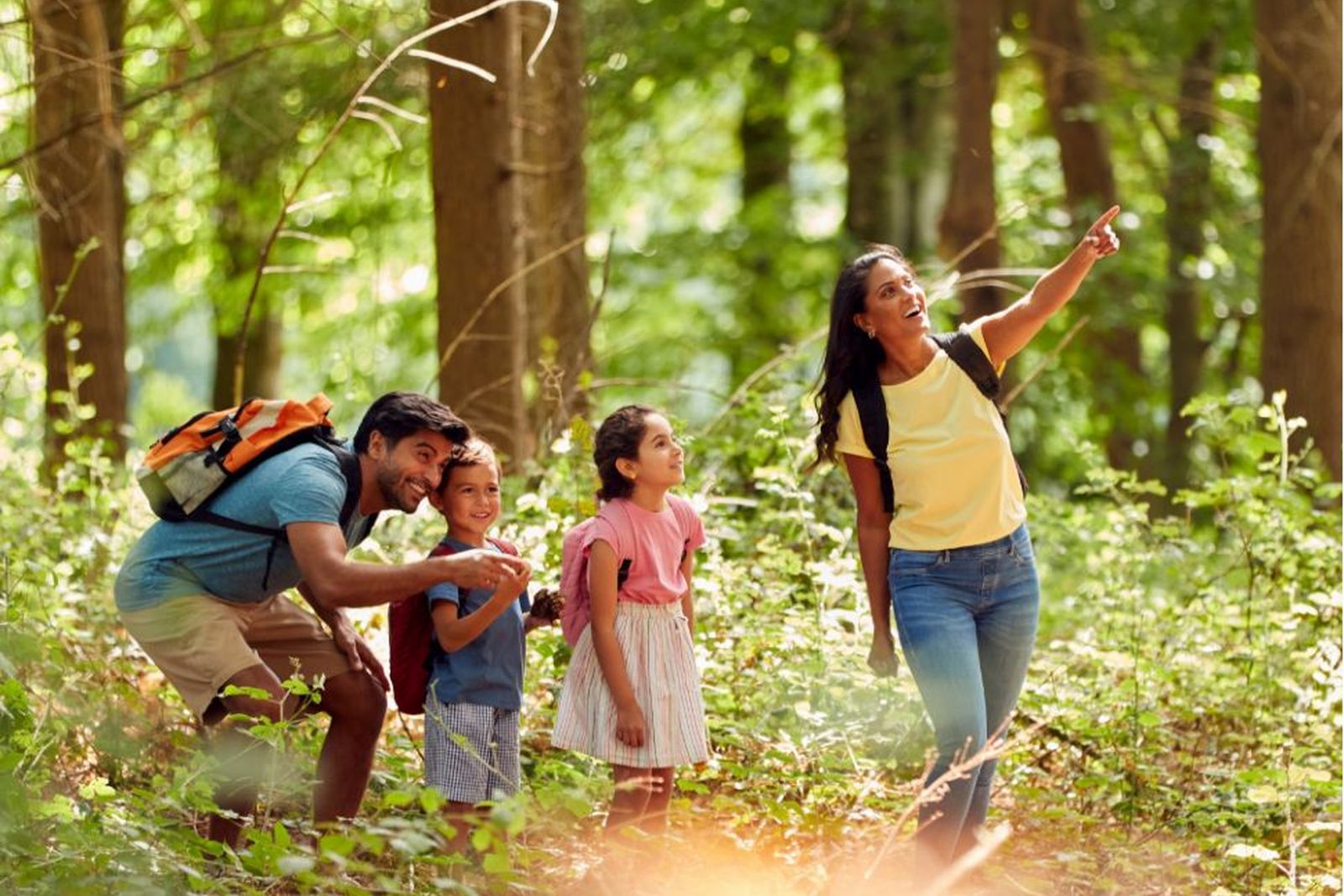 A family hiking a wooded trail near The Trails in New Caney, Texas