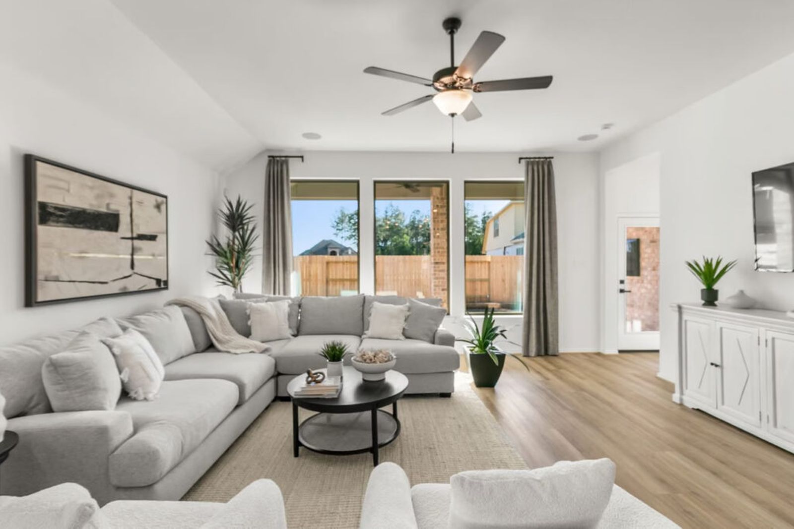 Dining and living space in a Coventry Homes model at The Trails